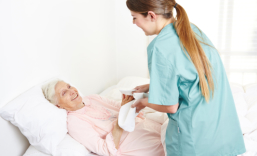 caregiver and elderly couple smiling