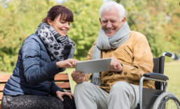 caregiver teaching patient how to use a tablet