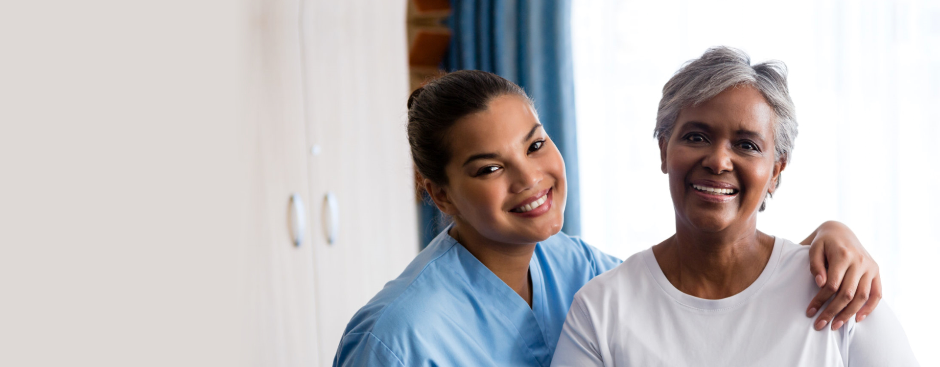 caregiver and senior woman smiling